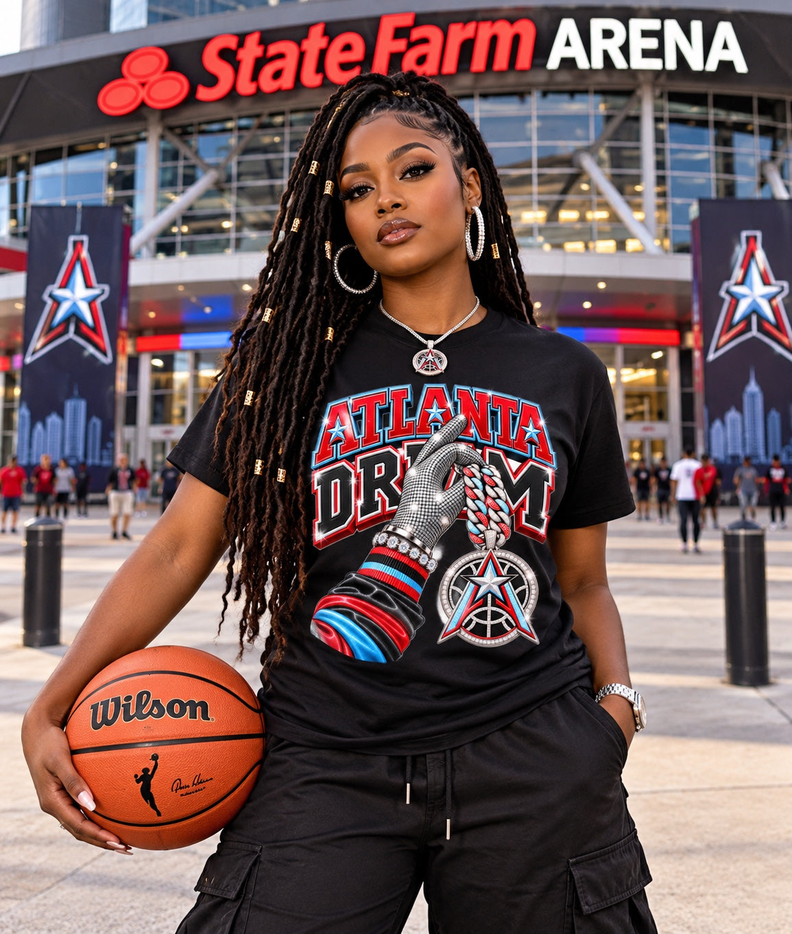Black Atlanta Dream graphic T-shirt with silver glove and star pendant, modeled outside State Farm Arena