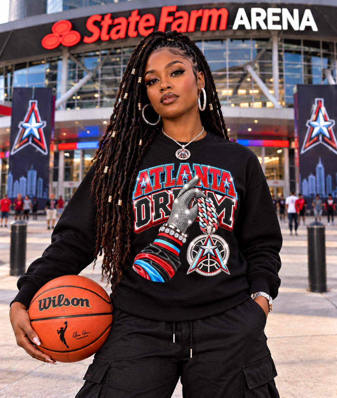 Black Atlanta Dream graphic sweatshirt modeled by a woman holding a basketball outside State Farm Arena