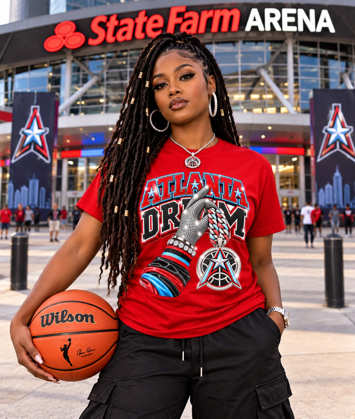 Red Atlanta Dream graphic T-shirt with silver glove and star pendant, modeled outside State Farm Arena