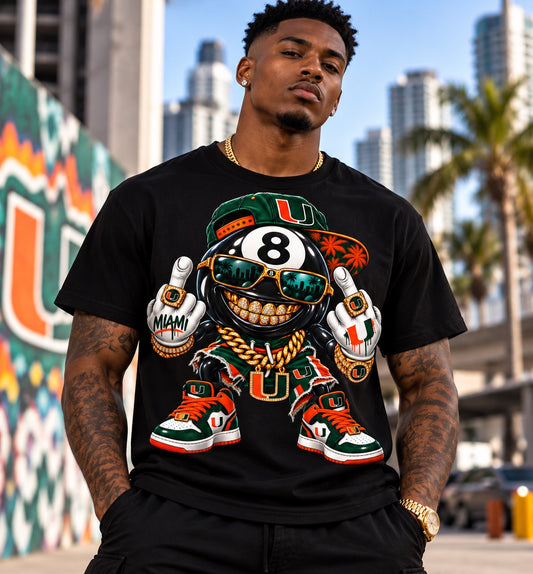 Black University of Miami 8 Ball graphic T-shirt with gold grill, green cap and orange-green sneakers